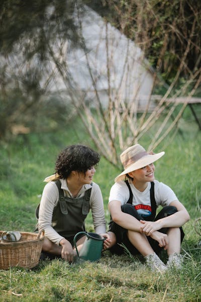 Gardeners taking a break on the lawn with watering cans